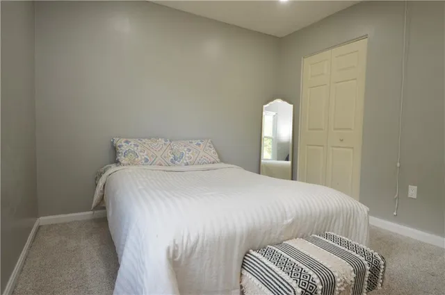 a bedroom with a bed and a mirror