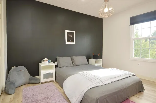 a bedroom with a bed and a chair