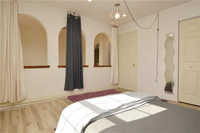 a bedroom with bed and a window