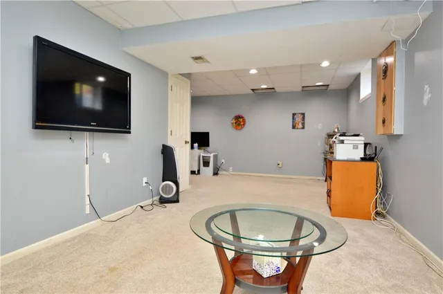 a room with gym equipment and a flat screen tv