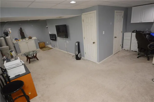 a room with gym equipment and a flat screen tv