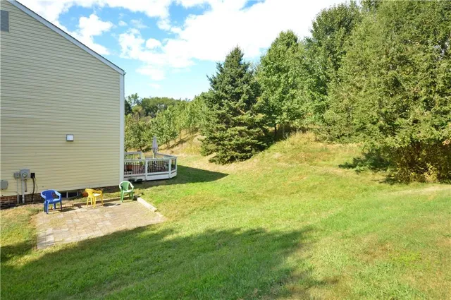 a backyard of a house with yard and outdoor seating
