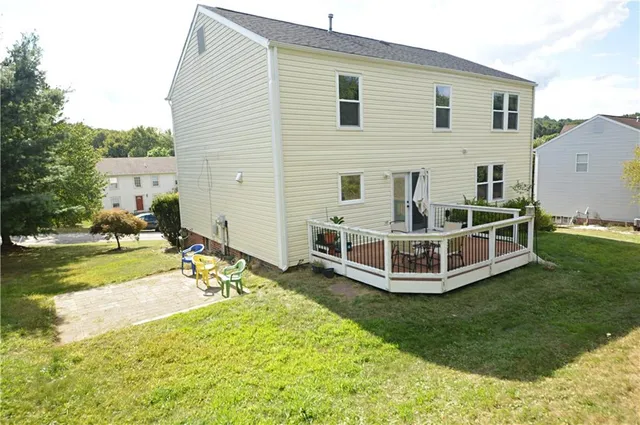 a view of a house with backyard and sitting area
