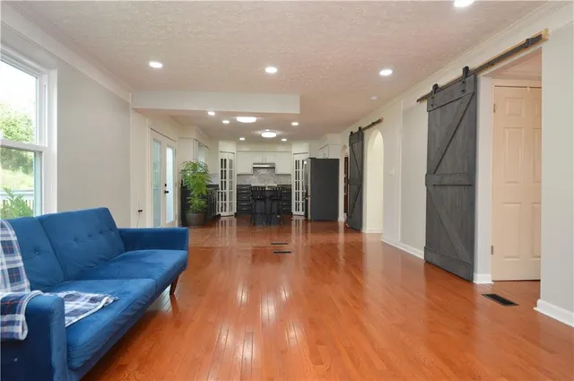 a living room with furniture and a wooden floor