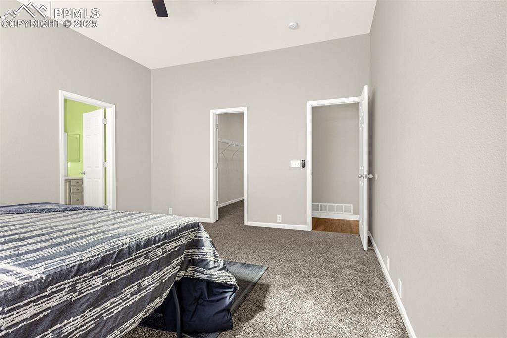 12383 Pine Valley Circle Peyton, CO 80831 - Photo 12 of 45 a bedroom with a bed and a couch