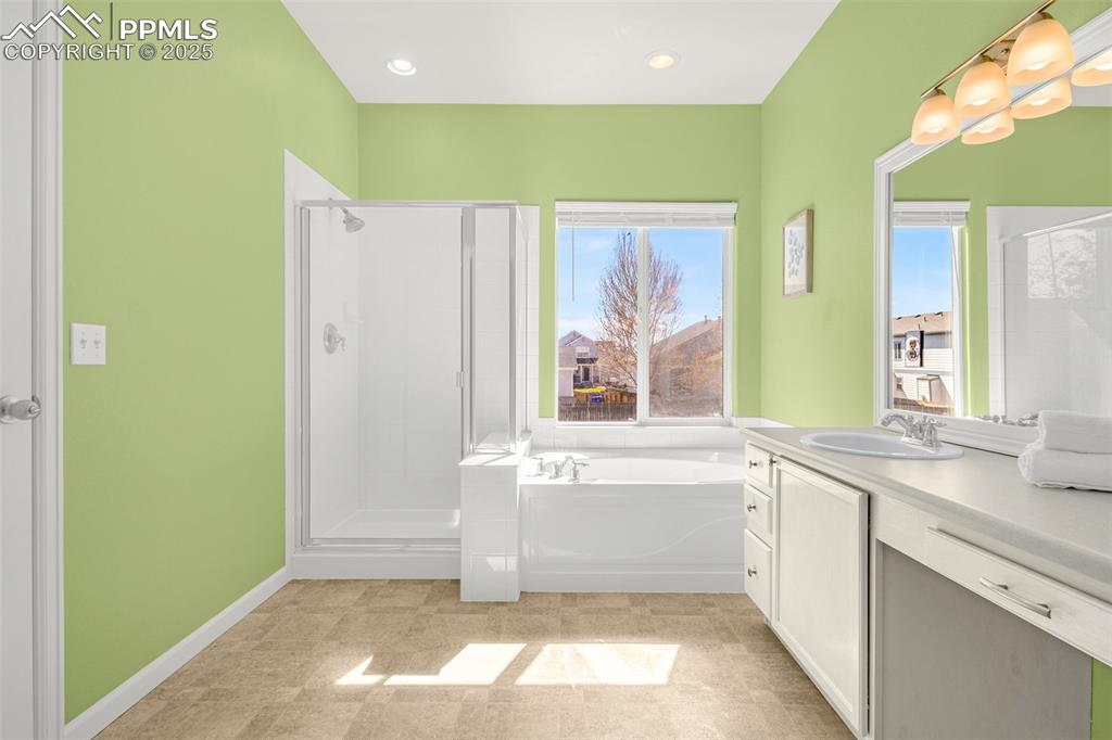 12383 Pine Valley Circle Peyton, CO 80831 - Photo 13 of 45 a bathroom with a tub sink and mirror