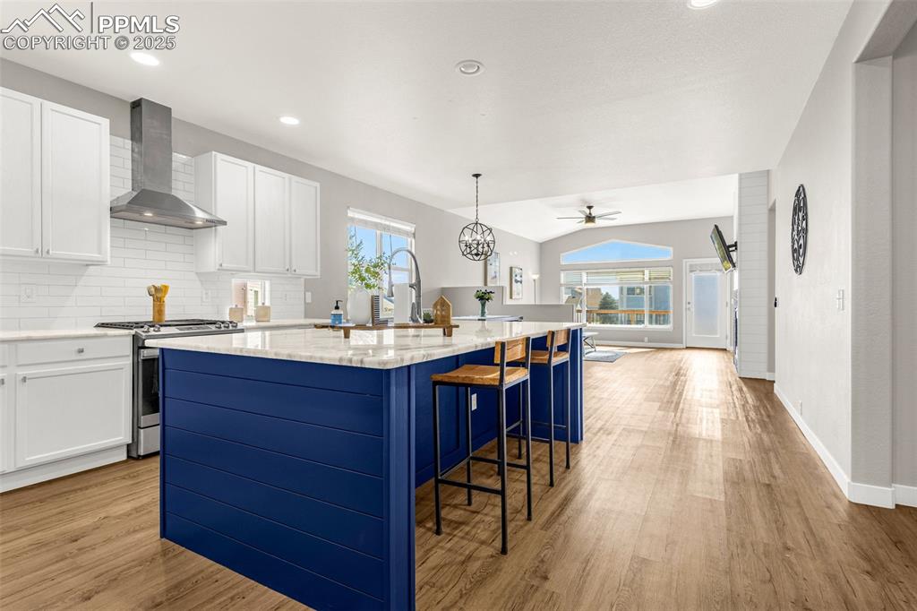 12383 Pine Valley Circle Peyton, CO 80831 - Photo 16 of 45 a kitchen with stainless steel appliances granite countertop wooden floors sink and cabinets