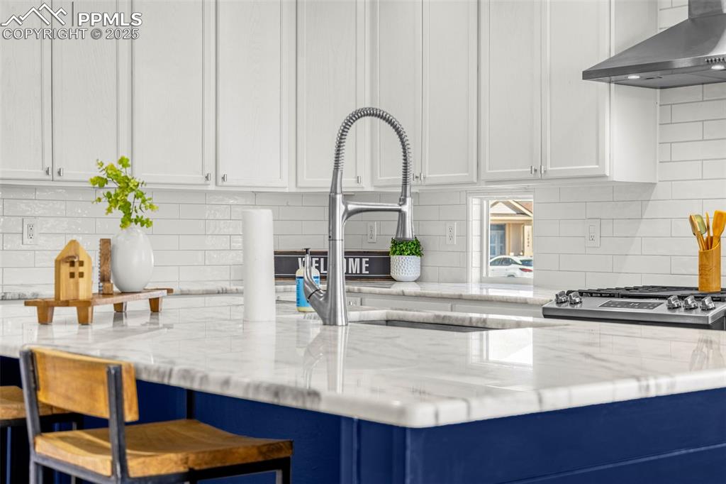 12383 Pine Valley Circle Peyton, CO 80831 - Photo 18 of 45 a kitchen with stainless steel appliances granite countertop a sink a stove and white cabinets