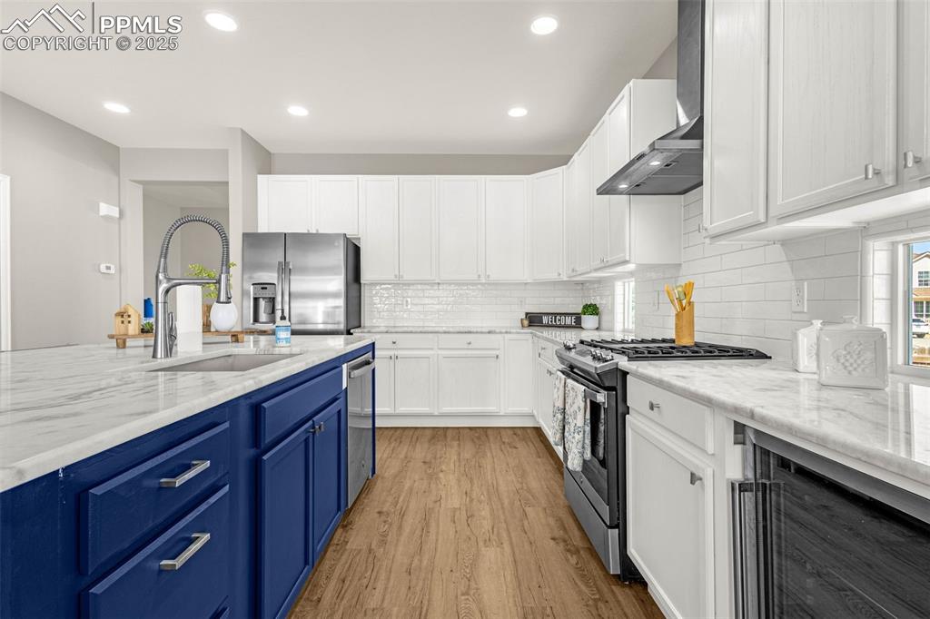 12383 Pine Valley Circle Peyton, CO 80831 - Photo 22 of 45 a kitchen with a sink a stove and cabinets