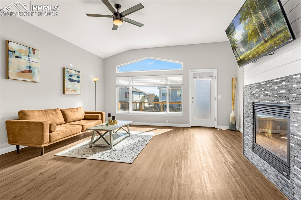 12383 Pine Valley Circle Peyton, CO 80831 - Photo 25 of 45 a living room with furniture and a fireplace