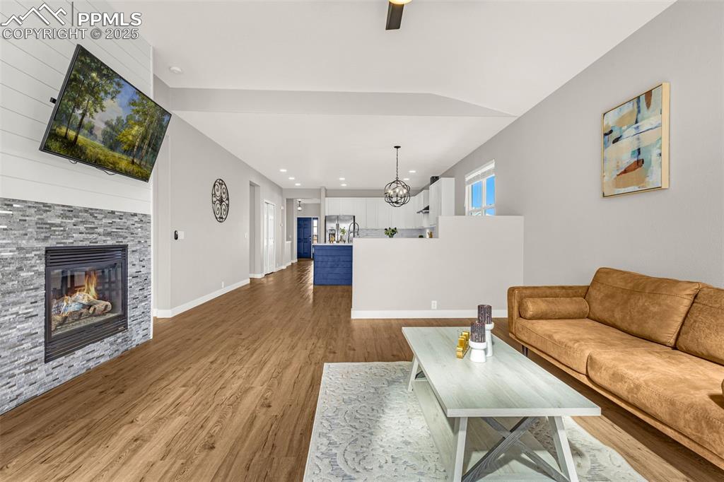12383 Pine Valley Circle Peyton, CO 80831 - Photo 27 of 45 a living room with furniture and a fireplace