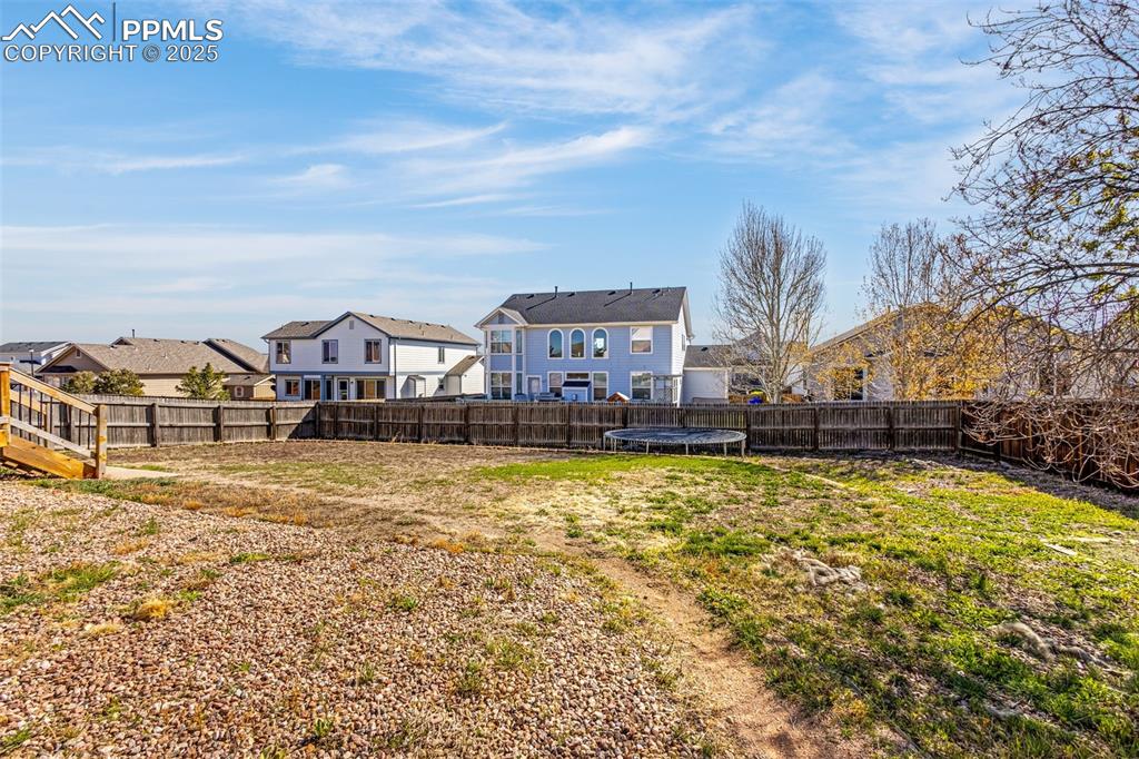 12383 Pine Valley Circle Peyton, CO 80831 - Photo 31 of 45 a front view of a house with swimming pool and mountains in the background