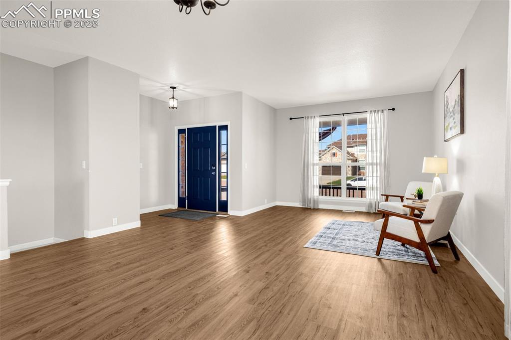 12383 Pine Valley Circle Peyton, CO 80831 - Photo 4 of 45 wooden floor in an empty room with a window