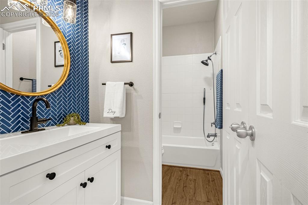 12383 Pine Valley Circle Peyton, CO 80831 - Photo 6 of 45 a bathroom with a sink a mirror and a shower