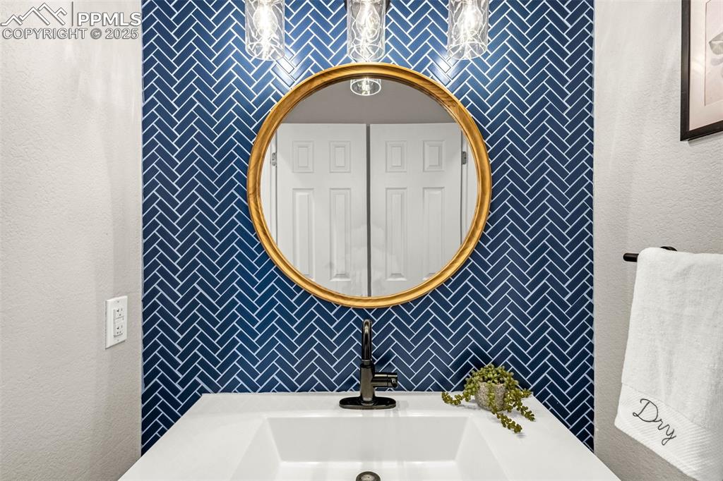 12383 Pine Valley Circle Peyton, CO 80831 - Photo 7 of 45 a bathroom with a sink and a mirror