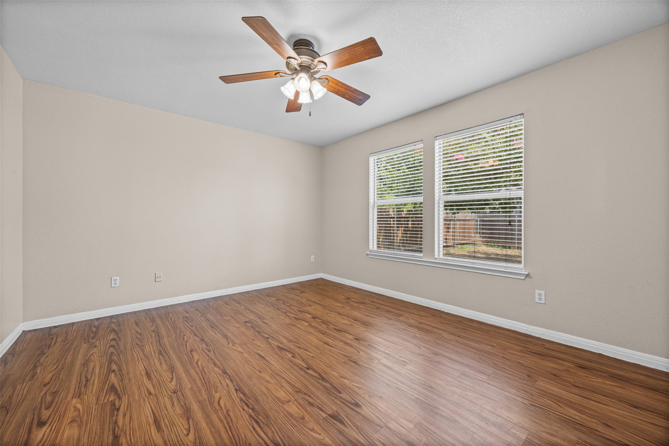2432 Roundabout Lane Round Rock, TX 78664 - Photo 11 of 22 A comfortable bedroom featuring durable wood flooring and ample natural light.