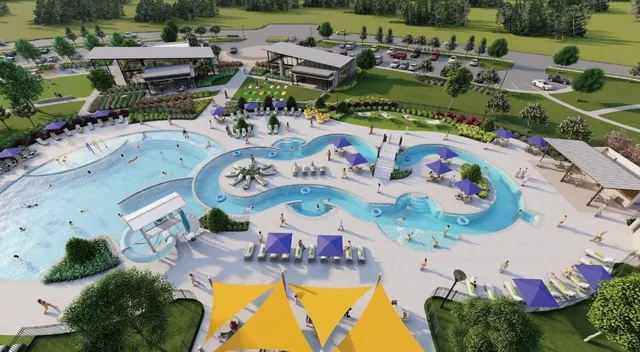 an aerial view of a swimming pool patio and lake view