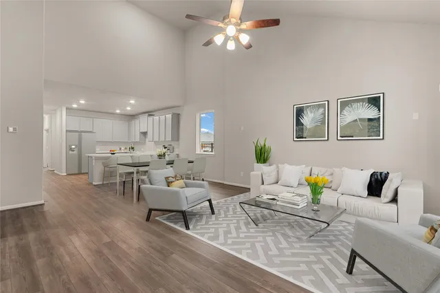 a living room with furniture and kitchen view