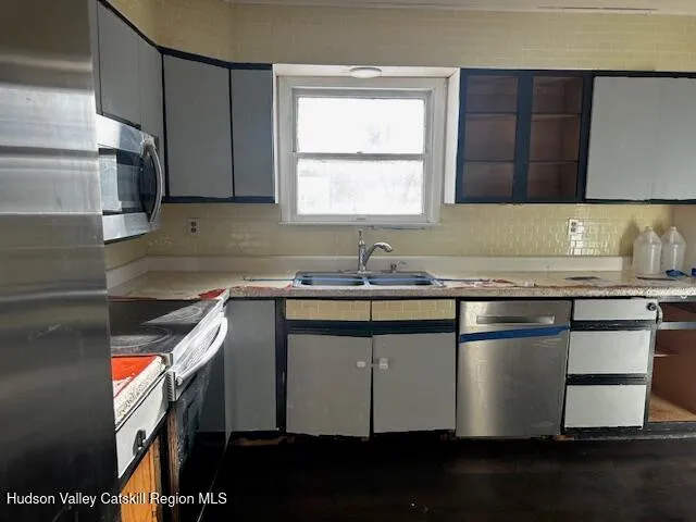 a kitchen with a sink cabinets and window