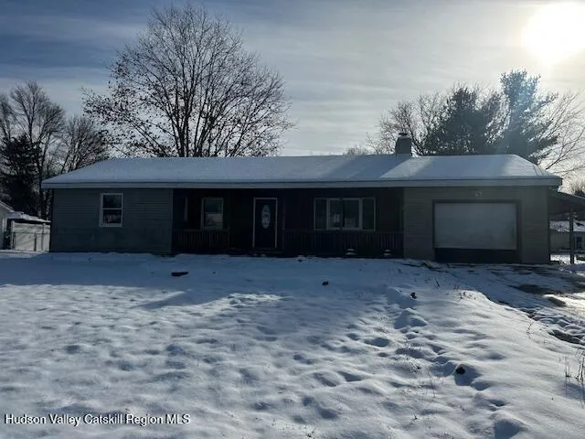 a front view of a house with a yard and a garage