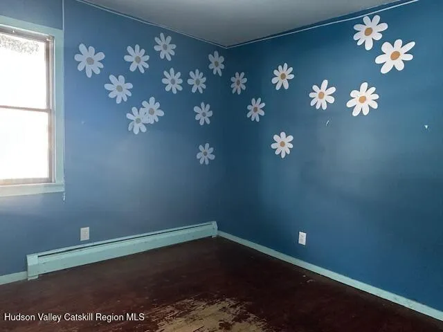 a view of a room with chandelier fan and wooden floor