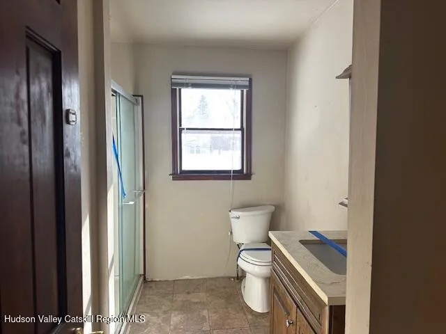 a white toilet sitting next to a bathroom sink