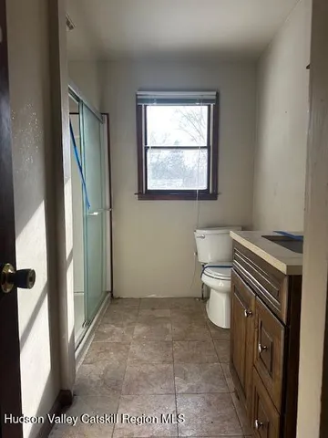 a bathroom with a sink a toilet and a mirror