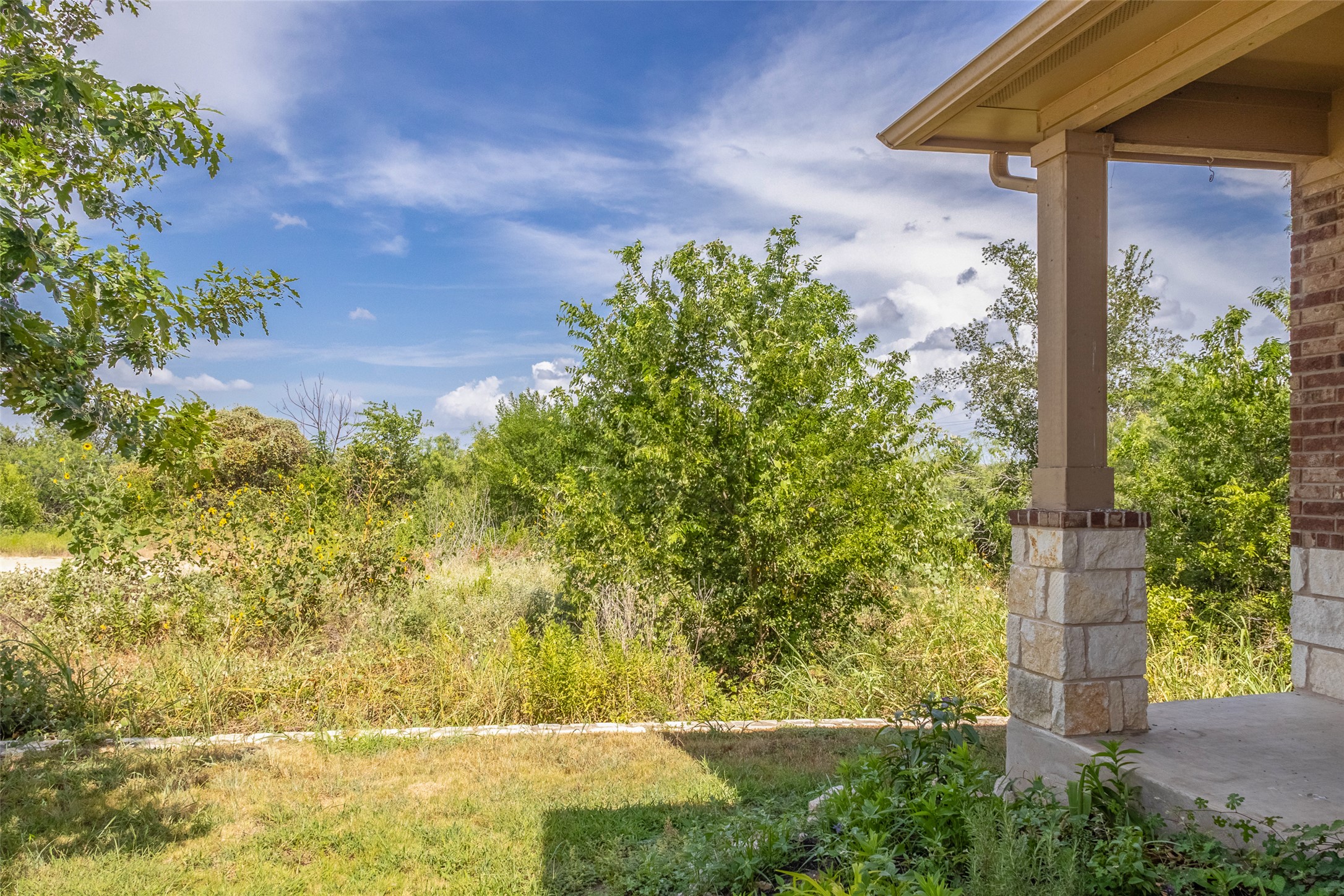 7225 Ranchito Drive Austin, TX 78744 - Photo 30 of 39 A quiet yard and a partially visible patio beckon for tranquil outdoor moments.
