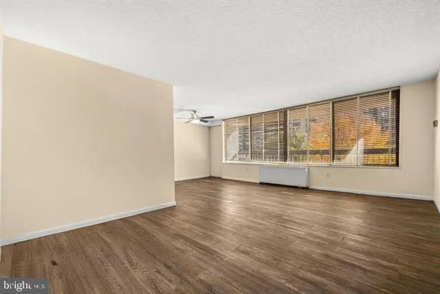 a view of wooden floor and windows in a room
