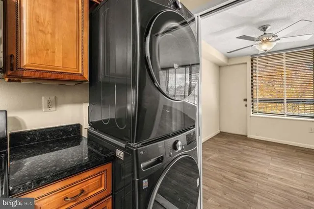 an empty room with wooden floor mirror and windows