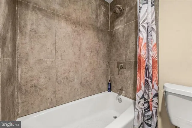 a bathroom with a bathtub and a toilet