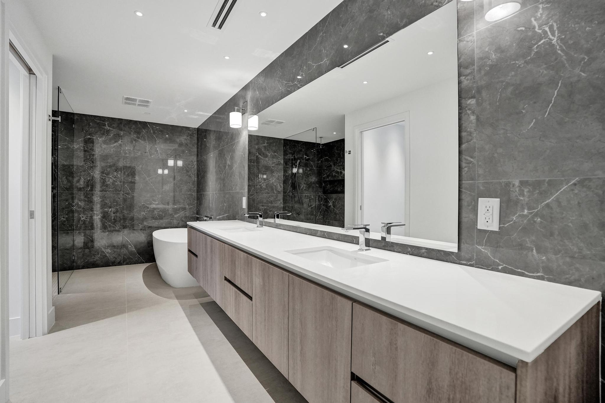 407 North Riverside Drive, Unit 602 Pompano Beach, FL 33062 - Photo 25 of 83 a bathroom with a granite countertop sink a toilet a mirror and shower