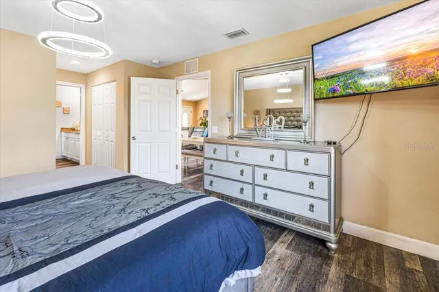 a living room with furniture a flat screen tv and a bookshelf