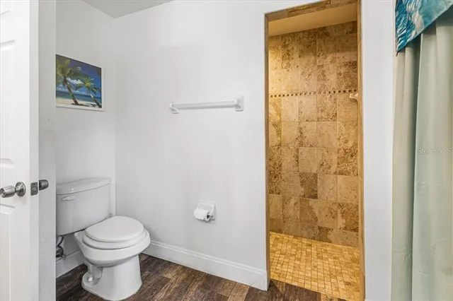 a bedroom with a bed and painting on the wall