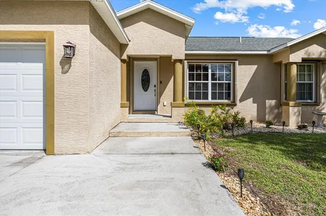 a living room with furniture flat screen tv and a window