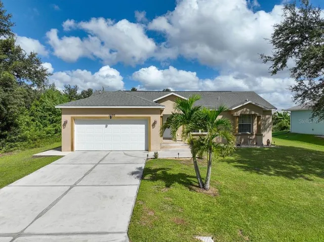 an aerial view of a house with a yard and lake view