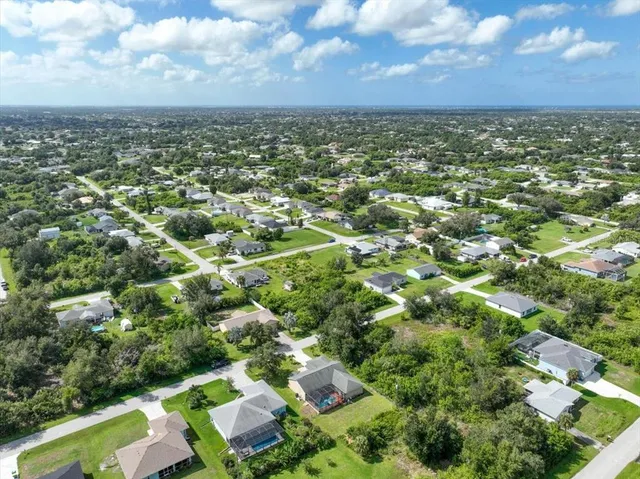 an aerial view of a house with a yard