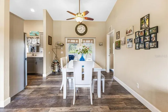 a living room with furniture kitchen view and a large window