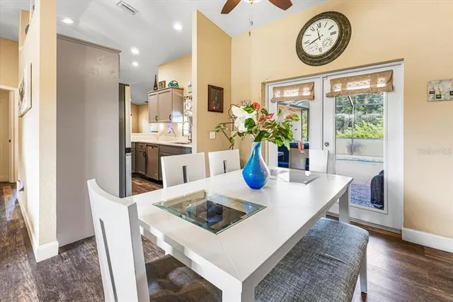 a kitchen with granite countertop stainless steel appliances a sink stove top oven and cabinets
