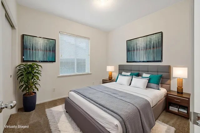 a view of an empty room with a fireplace and a window