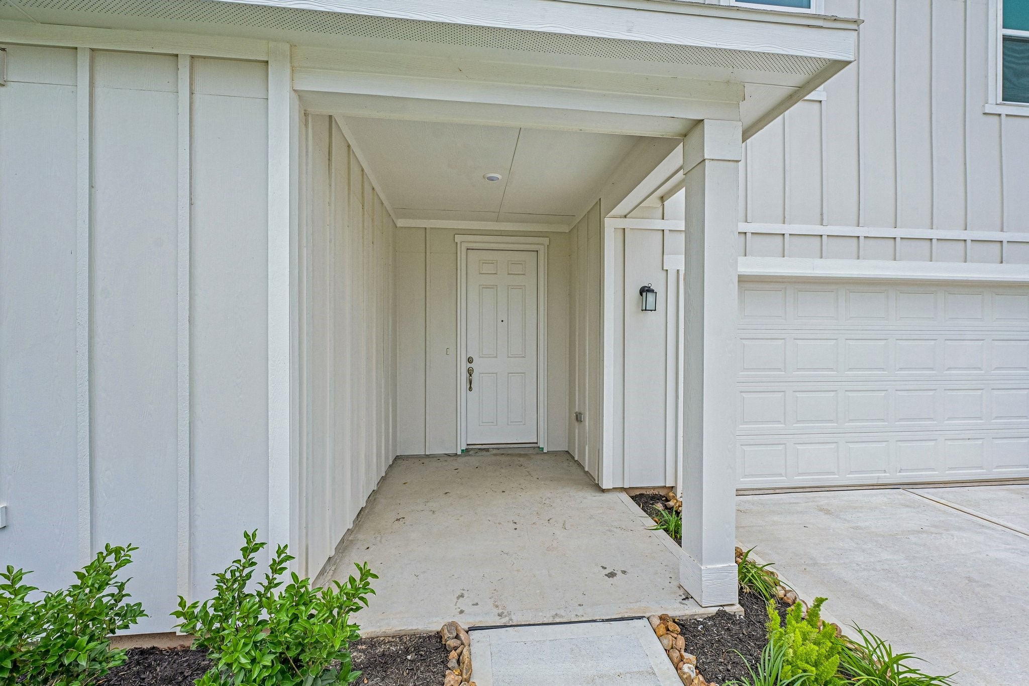 2503 Spruce Hl Road Beasley, TX 77417 - Photo 2 of 25 A welcoming large covered front patio sets the tone with clean architectural lines, a rich wood front door, and landscaped garden beds that create inviting curb appeal.