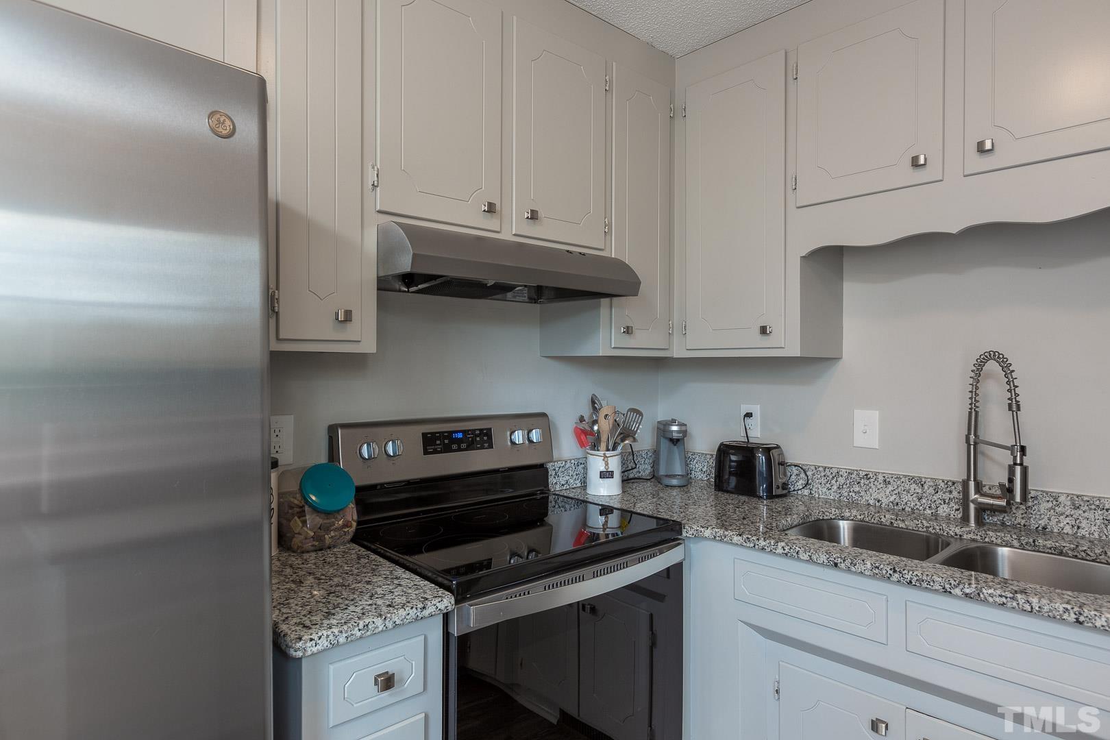 1558 Langdon Road Angier, NC 27501 - Photo 11 of 25 a kitchen with granite countertop a stove sink and cabinets