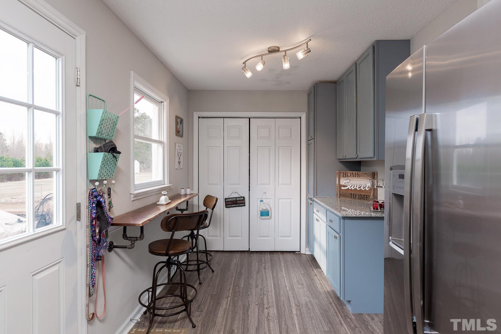 1558 Langdon Road Angier, NC 27501 - Photo 12 of 25 a kitchen with stainless steel appliances kitchen island granite countertop a refrigerator and a sink