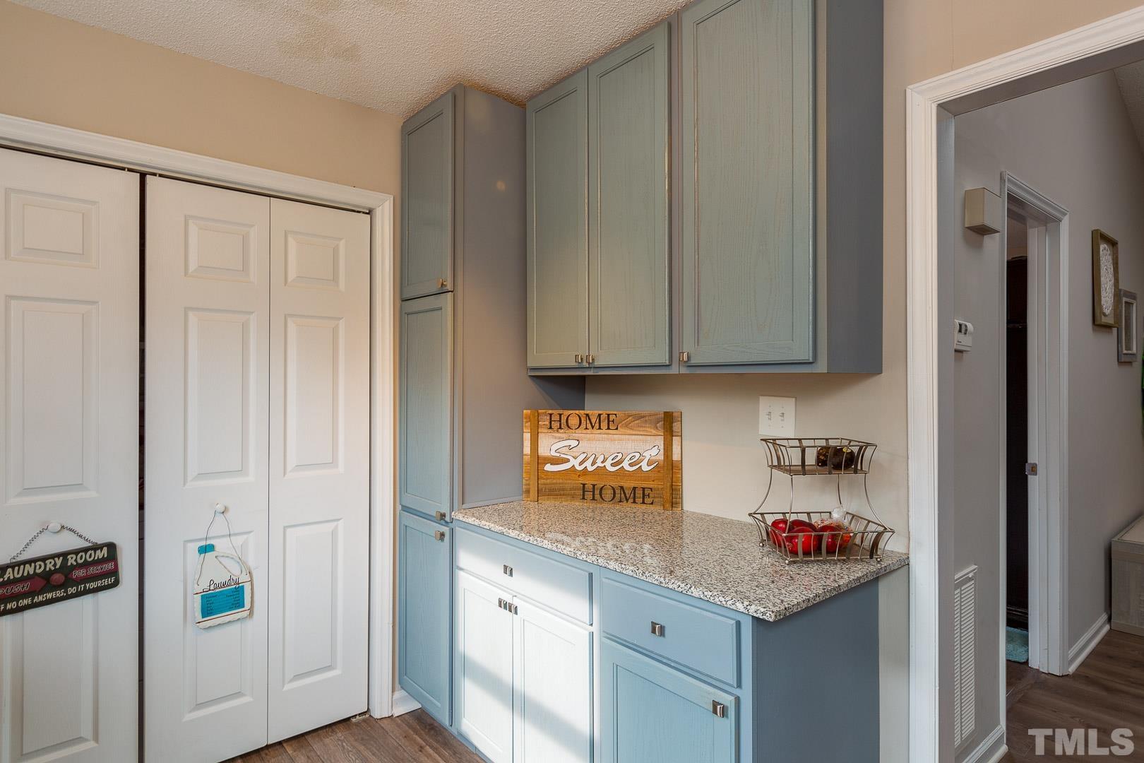 1558 Langdon Road Angier, NC 27501 - Photo 13 of 25 a kitchen with stainless steel appliances granite countertop white cabinets and a refrigerator