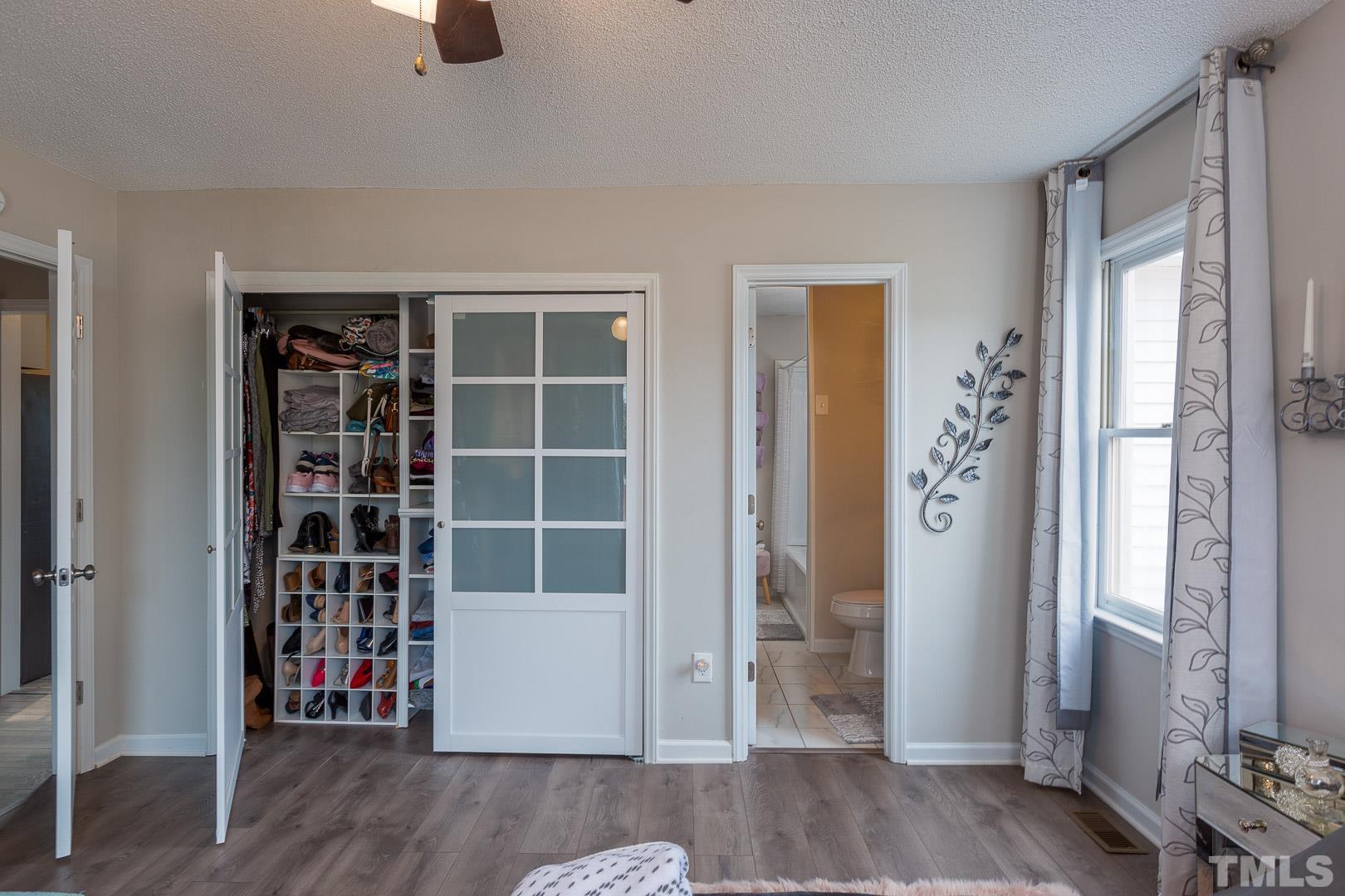1558 Langdon Road Angier, NC 27501 - Photo 15 of 25 a view of an empty room with wooden floor and a window