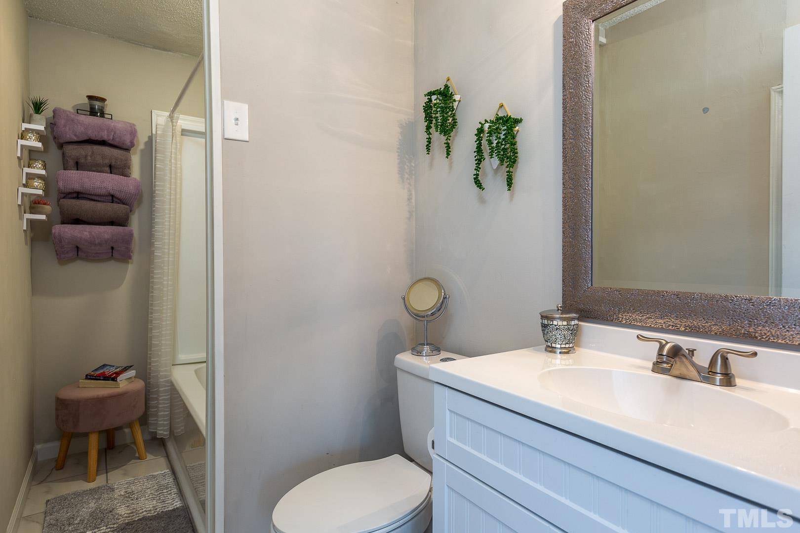 1558 Langdon Road Angier, NC 27501 - Photo 16 of 25 a bathroom with a sink toilet and shower