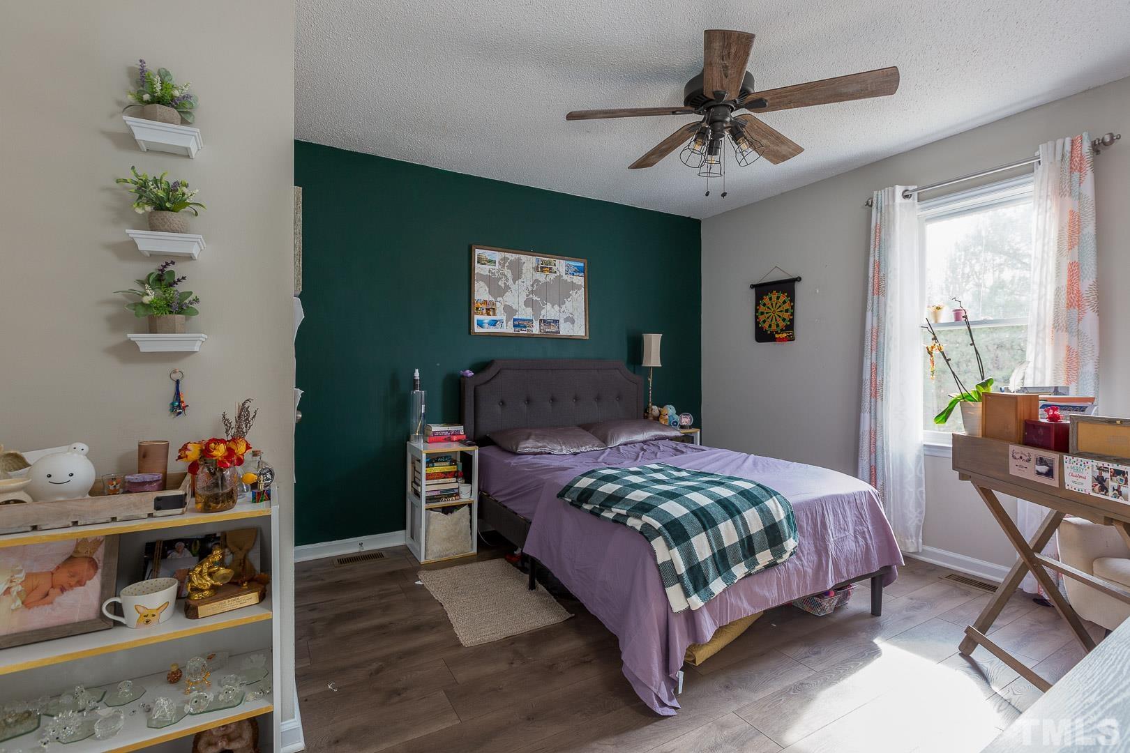 1558 Langdon Road Angier, NC 27501 - Photo 18 of 25 a bedroom with a bed and a chandelier