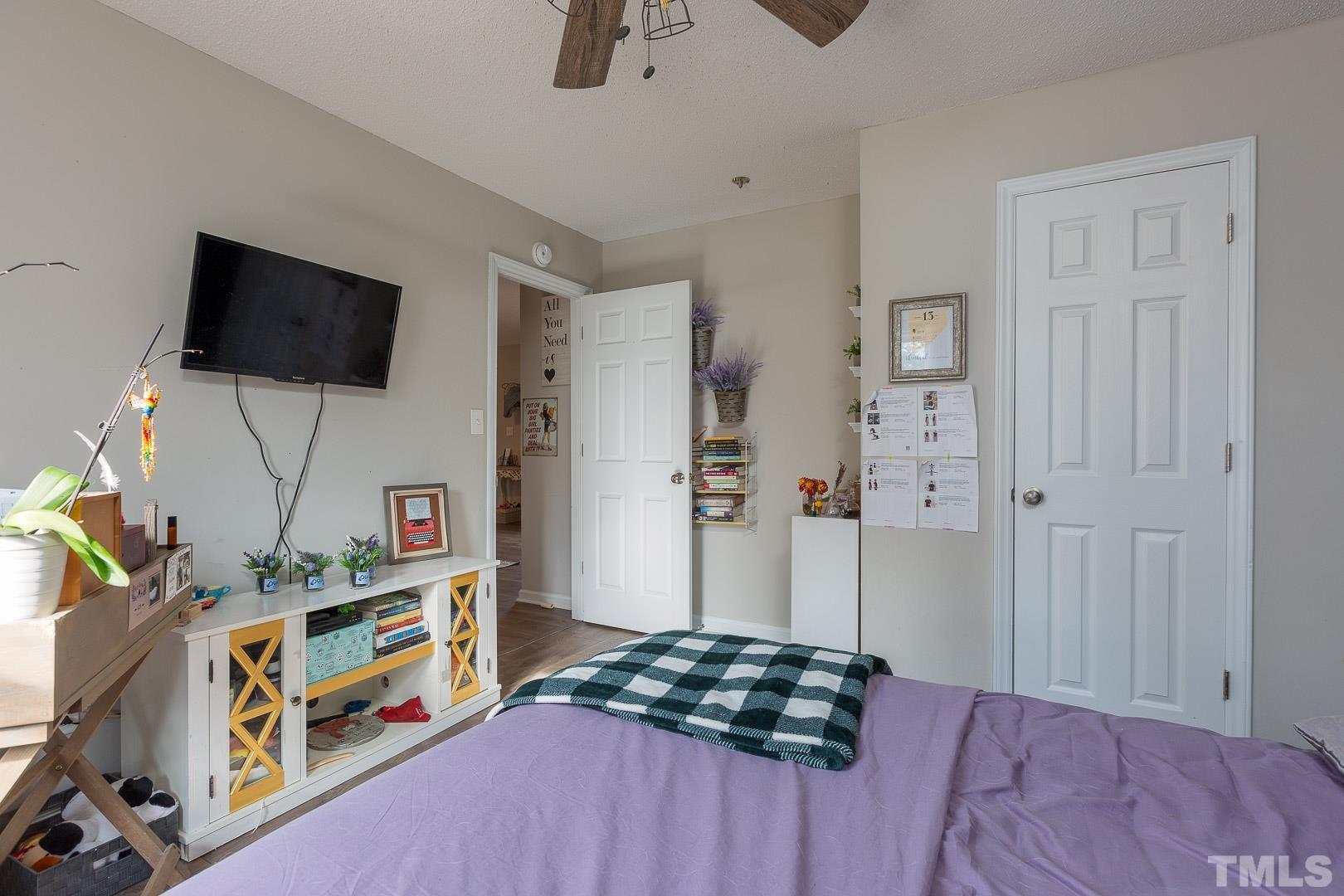 1558 Langdon Road Angier, NC 27501 - Photo 19 of 25 a bedroom with a bed and a flat screen tv