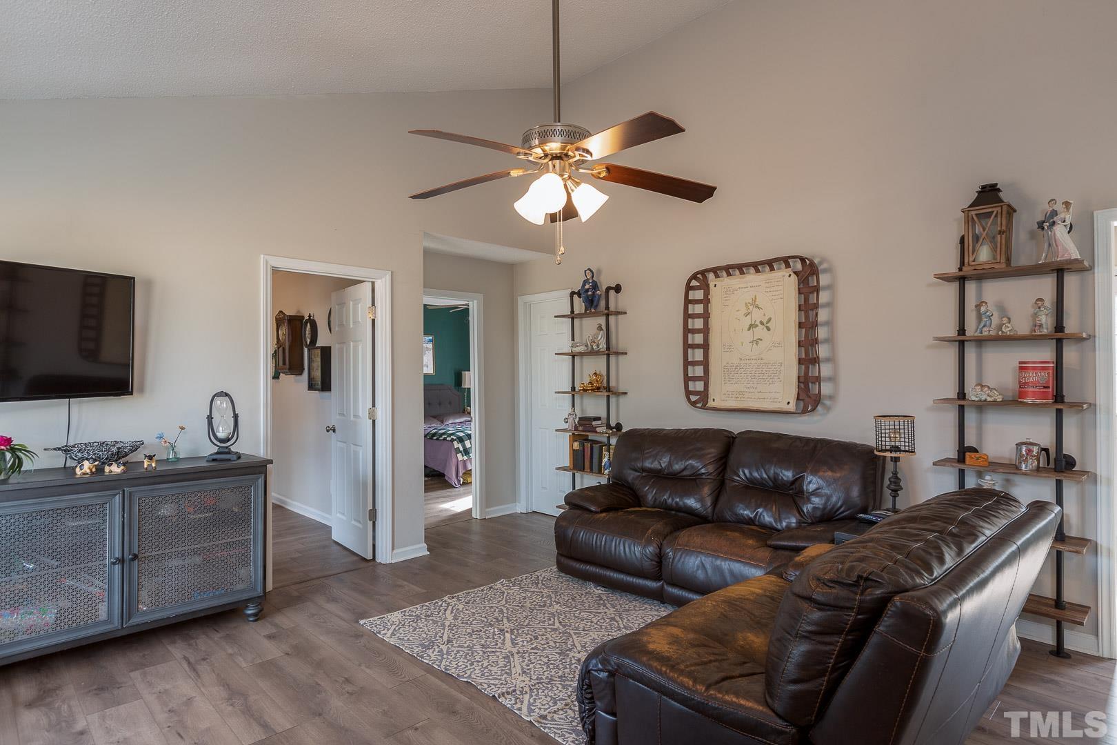 1558 Langdon Road Angier, NC 27501 - Photo 3 of 25 a living room with furniture and a flat screen tv