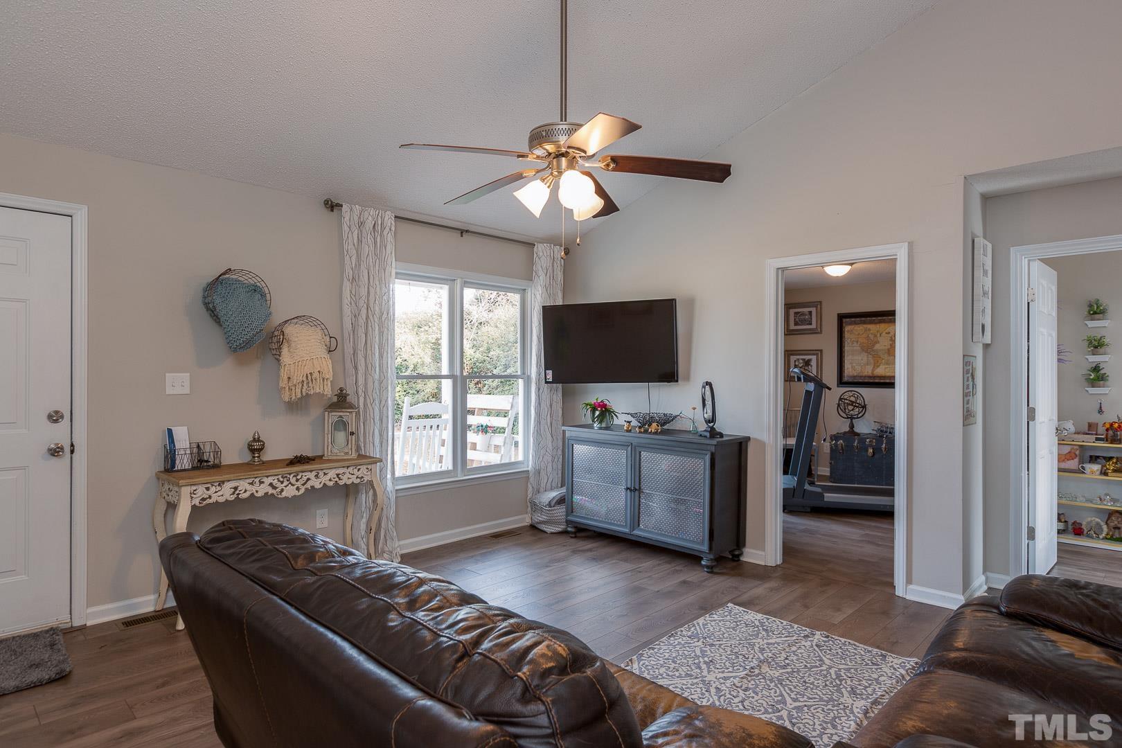 1558 Langdon Road Angier, NC 27501 - Photo 4 of 25 a living room with furniture and a flat screen tv